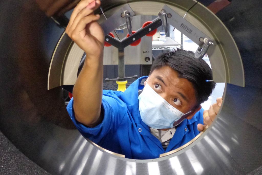 Male intern with mask working in a tight space