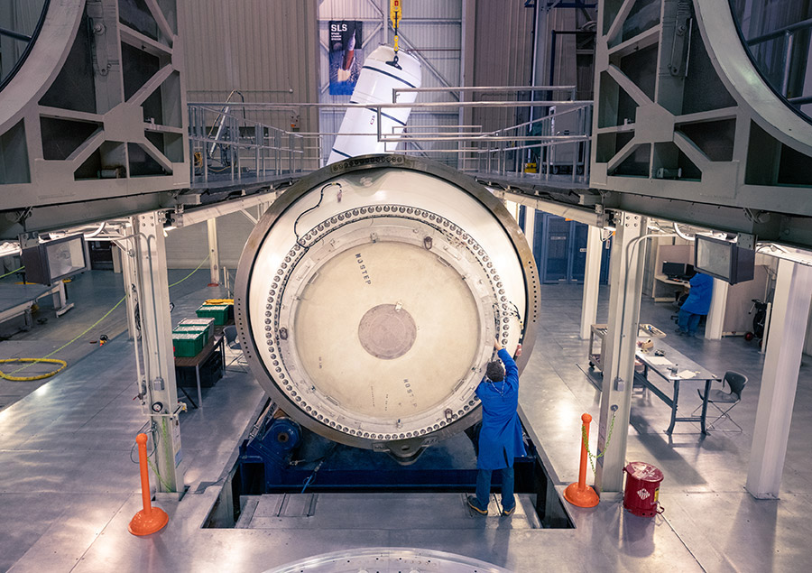 technician servicing a rocket