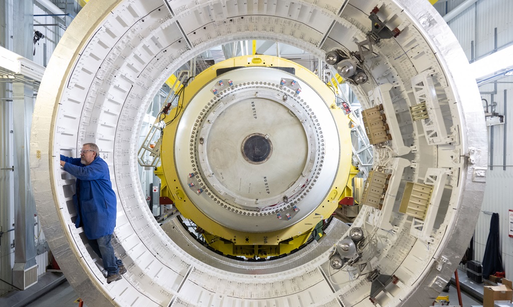 Engineer works on solid rocket motor