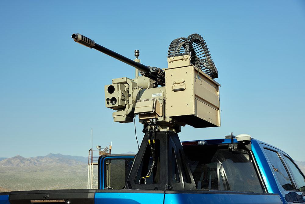 large gun mounted to bed of a pick-up truck