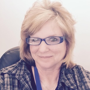 Up-close photo of female smiling with glasses