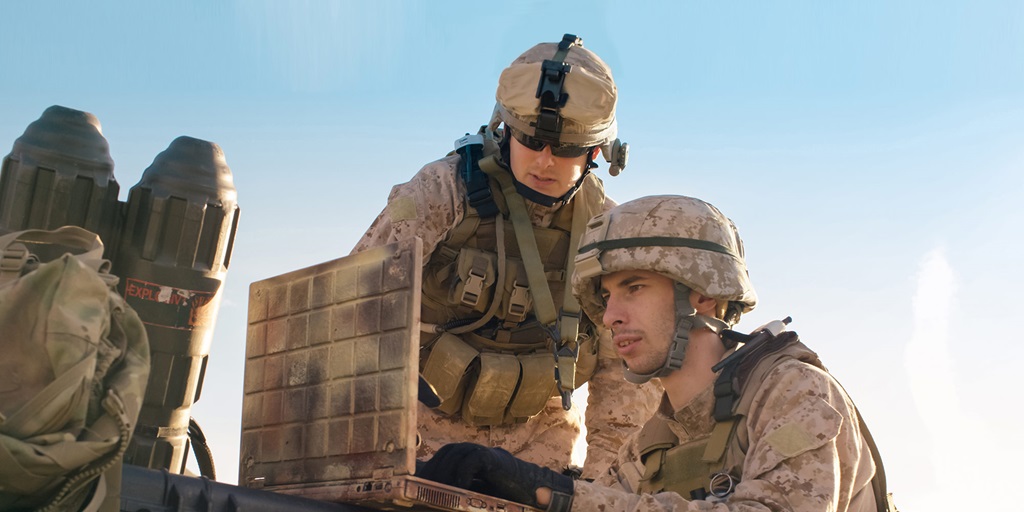 Soldiers Using Laptop Computer for Surveillance During Military Operation in the Desert