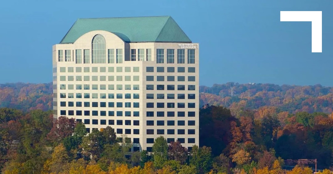 Building amongst green and gold color trees