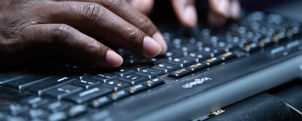 hands typing on a keyboard