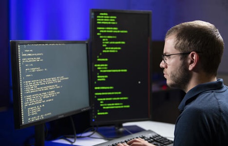 Northrop Grumman Employee looking at computer screen.