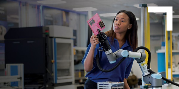 black woman holding robotic arm