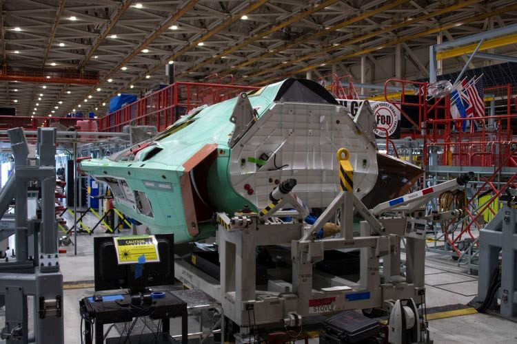 fighter aircraft fuselage on assembly line