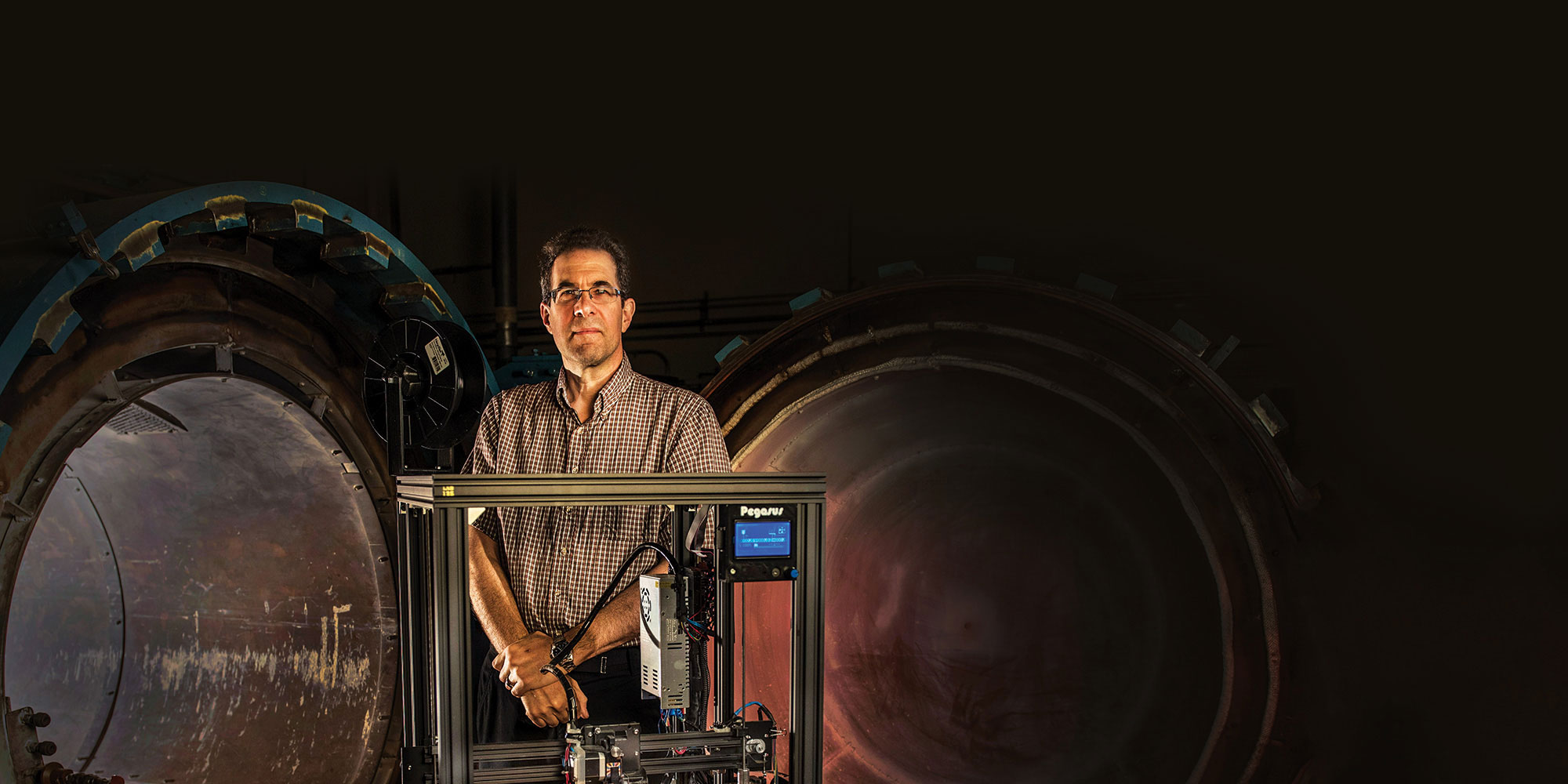 white man standing in front of giant gears