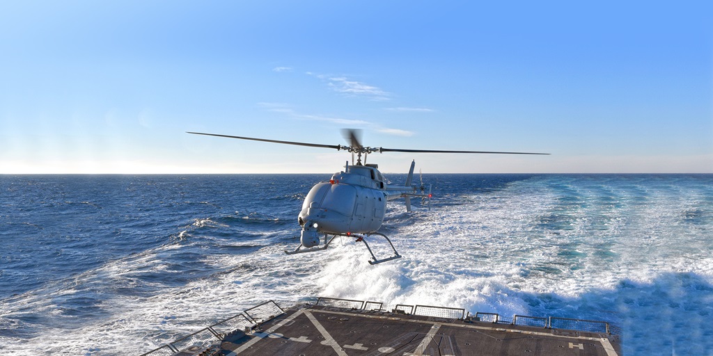 Unmanned helicopter flying above a landing pad in the sea