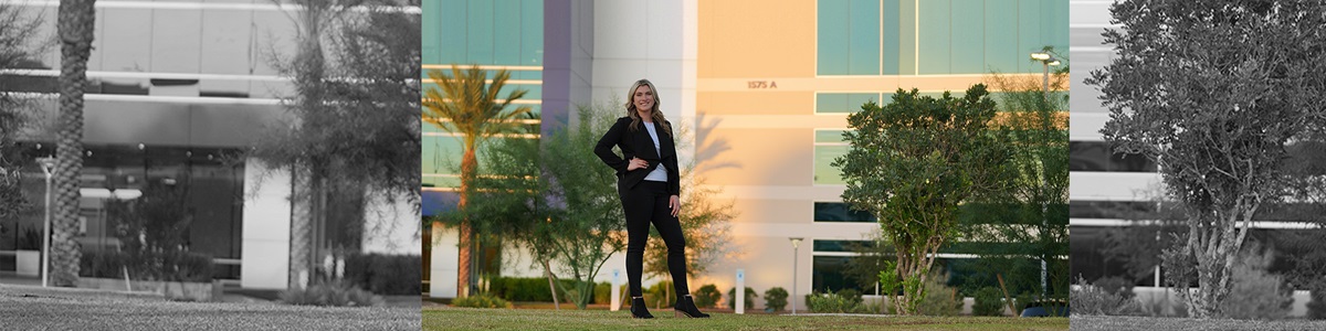 female standing in front of building