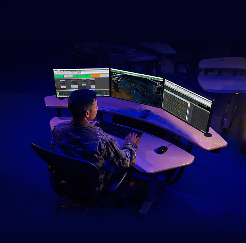 miltary man sitting at computer screens