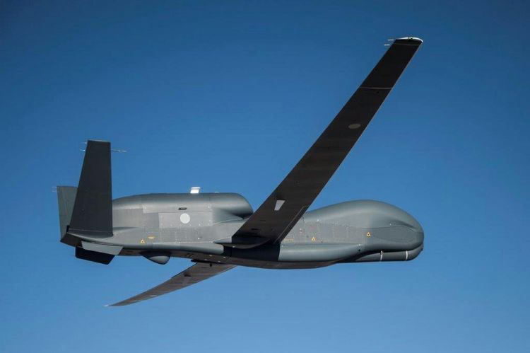 Global Hawk flies against a blue sky