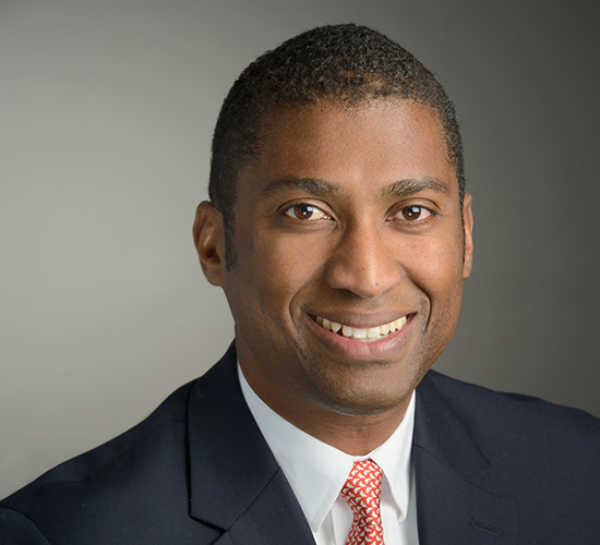 Photo of Graham Robinson - man smiling in suit and tie 