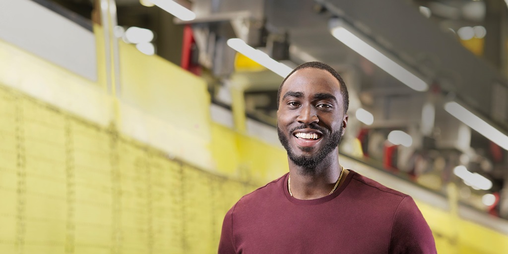 Smiling Black male in large warehouse