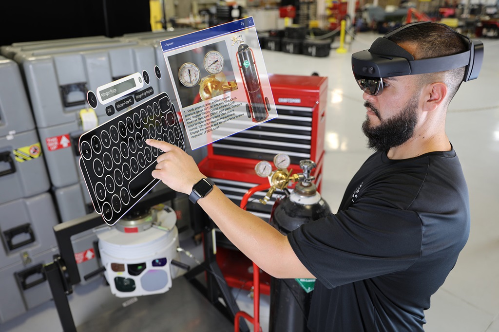 a man wears an augmented reality headset and types on a virtual keyboard