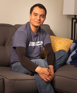 man smiling while sitting on couch