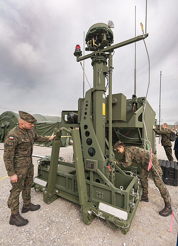 two soldiers working with battle hardware