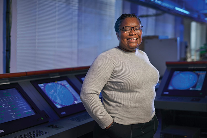 woman standing next to ship monitors