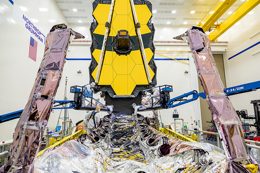 clean room with telescope being worked on by technicians