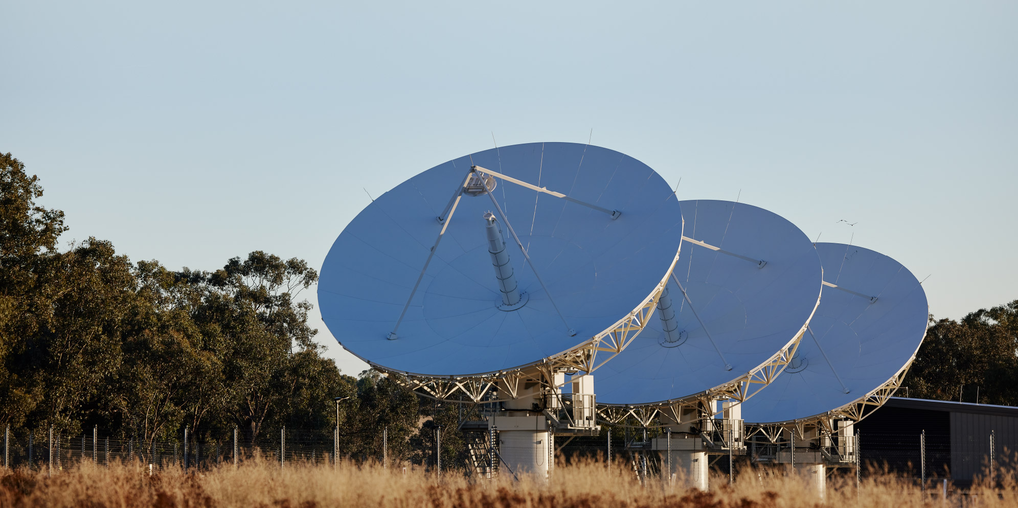 three large satillite dishes lined up