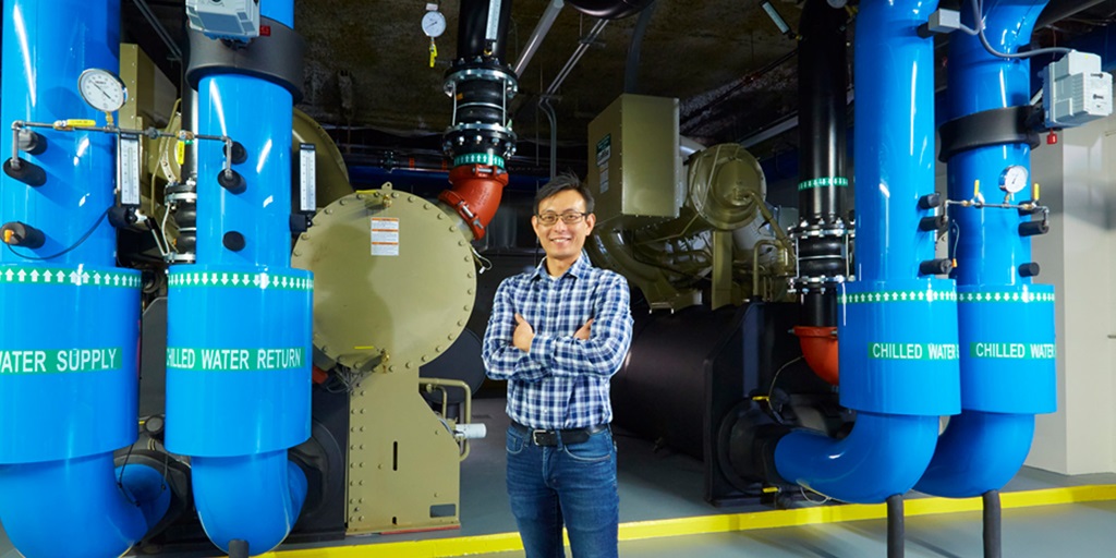 man standing next to hydronic heating and cooling system