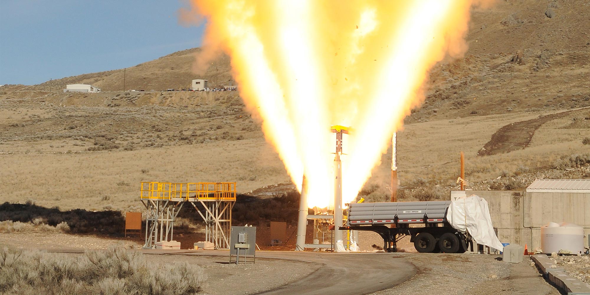 Keeping Astronauts Safe with NASA’s Orion Spacecraft’s Launch Abort System flames shooting from rocket test in desert