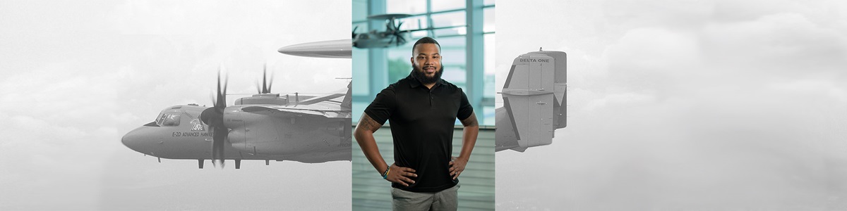 male standing in front of airplane model