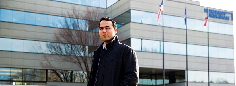 man in suit standing outside office building