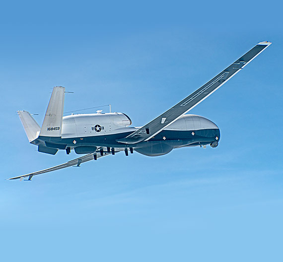 unmanned surveillance plane flying in blue skies