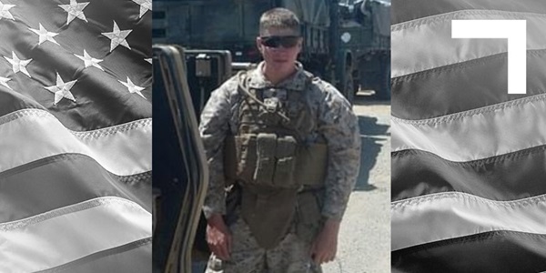 U.S. Marine Corps Veteran standing in front of military vehicles