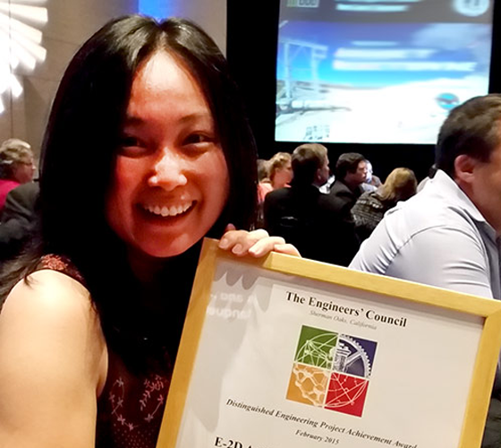 photo of woman holding award