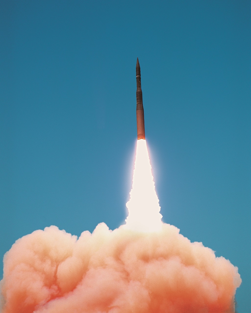 rocket launching in front of blue sky