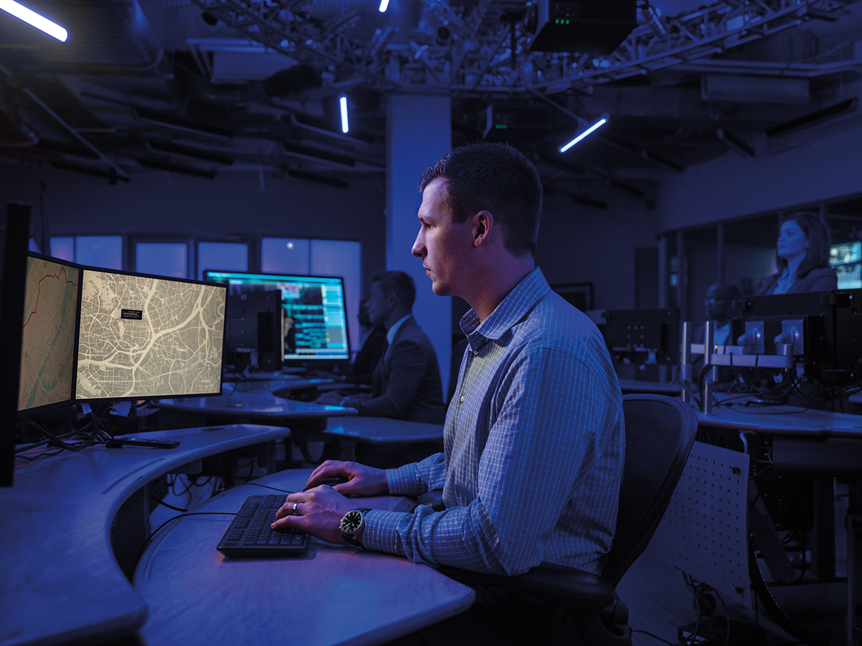 man at laptop in computer room