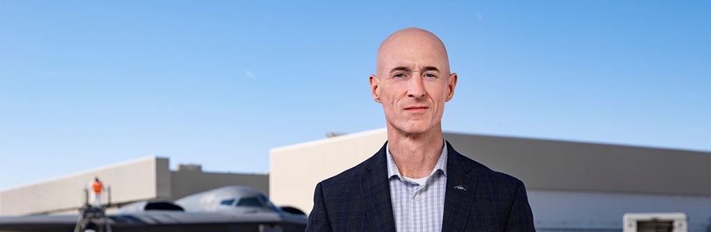 White man stands outside in front of B-2