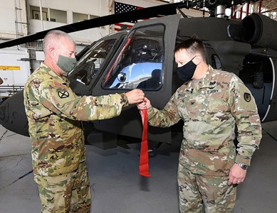 military man handing aircraft key to pilot