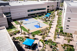 Aerial image of multi-level office building including a basketball court.