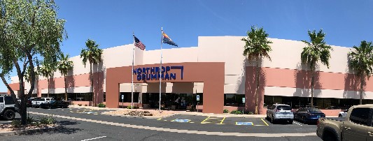 Artist rendering of an office building with palm trees and flags in the front.