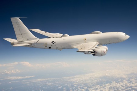 white military aircraft flying above clouds