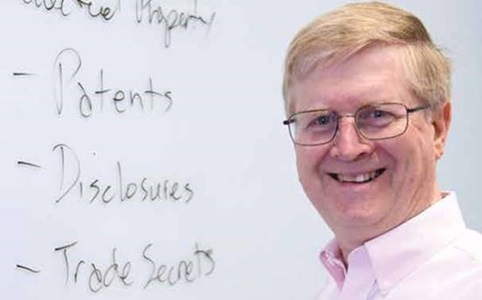 Headshot of Caucasian Male in front of whiteboard