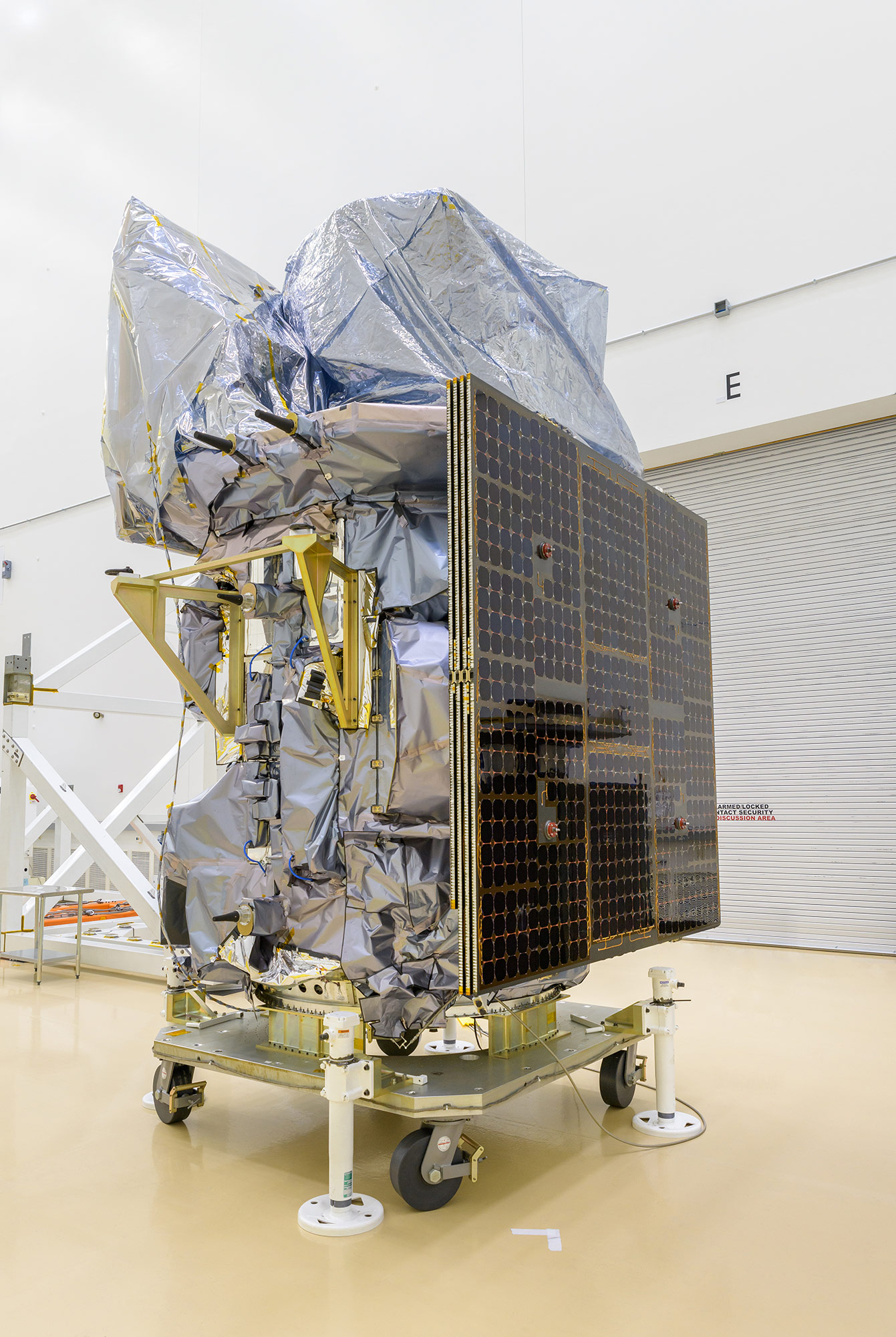 a large machine on wheels covered in foil with a photographic panel on one side