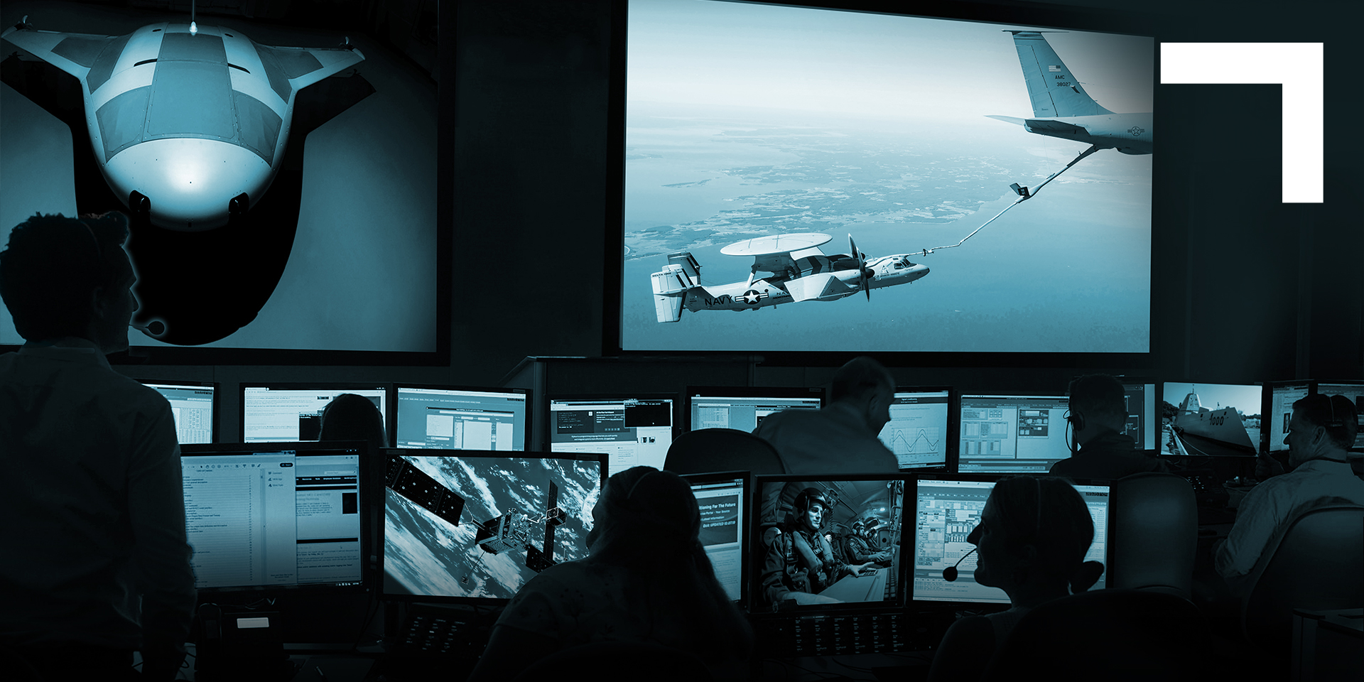 darkened photo of command center with monitors 