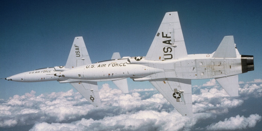 T-38 military airplane flying in the sky showing the belly side