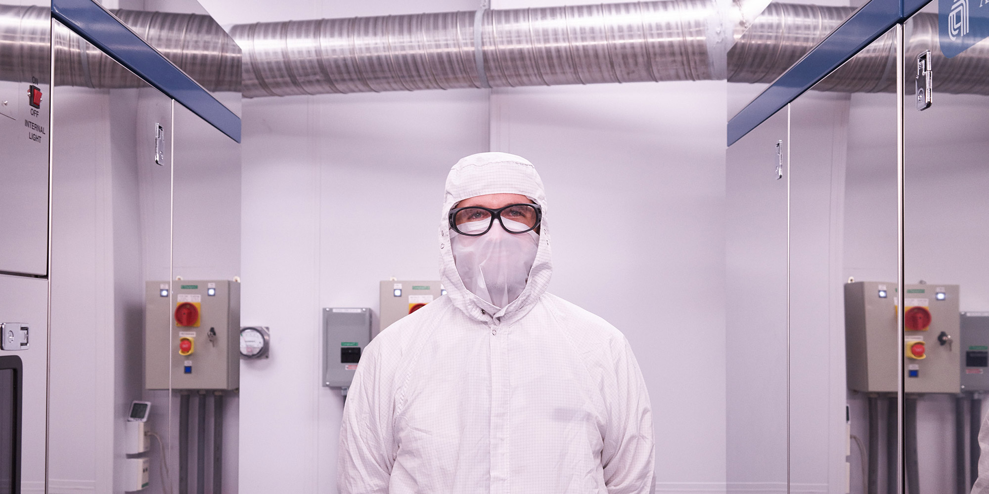 man in clean suit in clean room