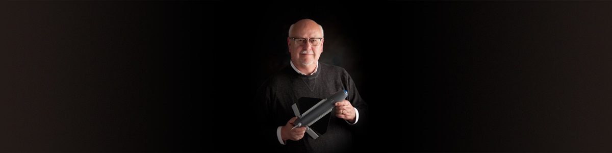 male holding a model of a munition