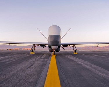 Triton aircraft on runway at sunset