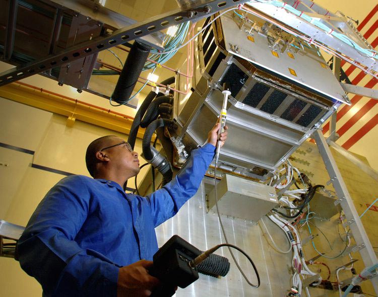 Man in lab suit testing equipment