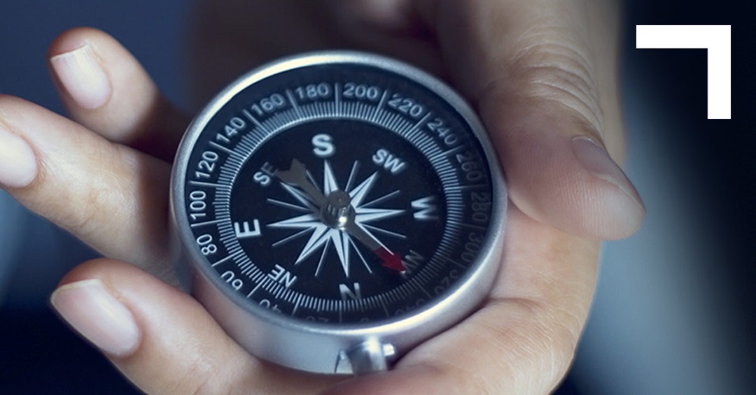 hand holding a compass
