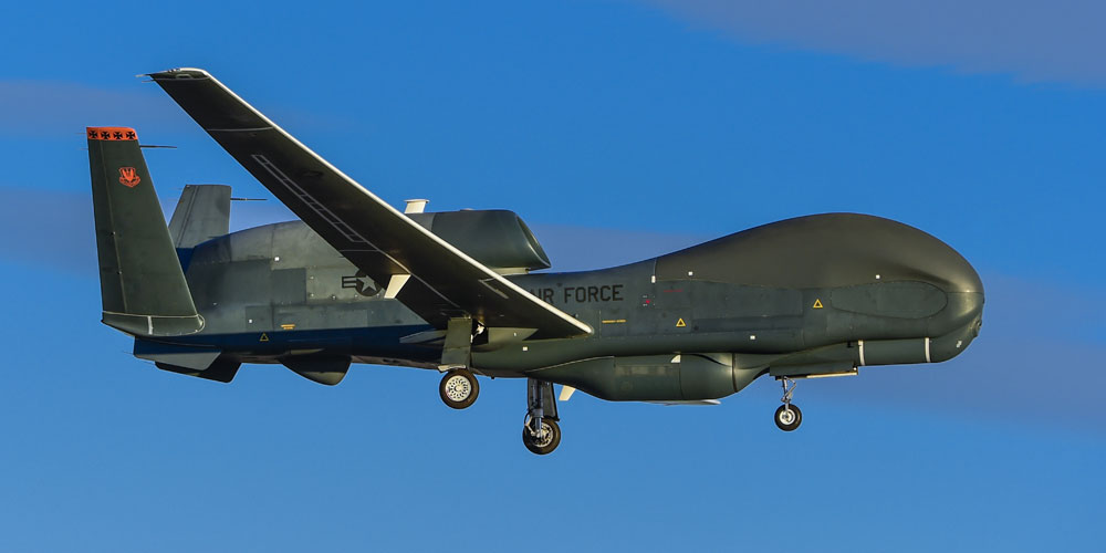 military plane flying in blue sky