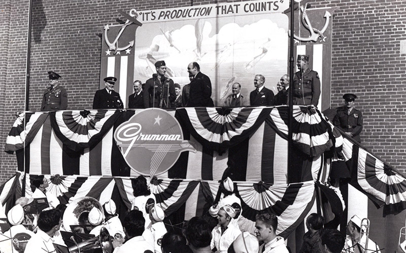 people on stage with bunting flags