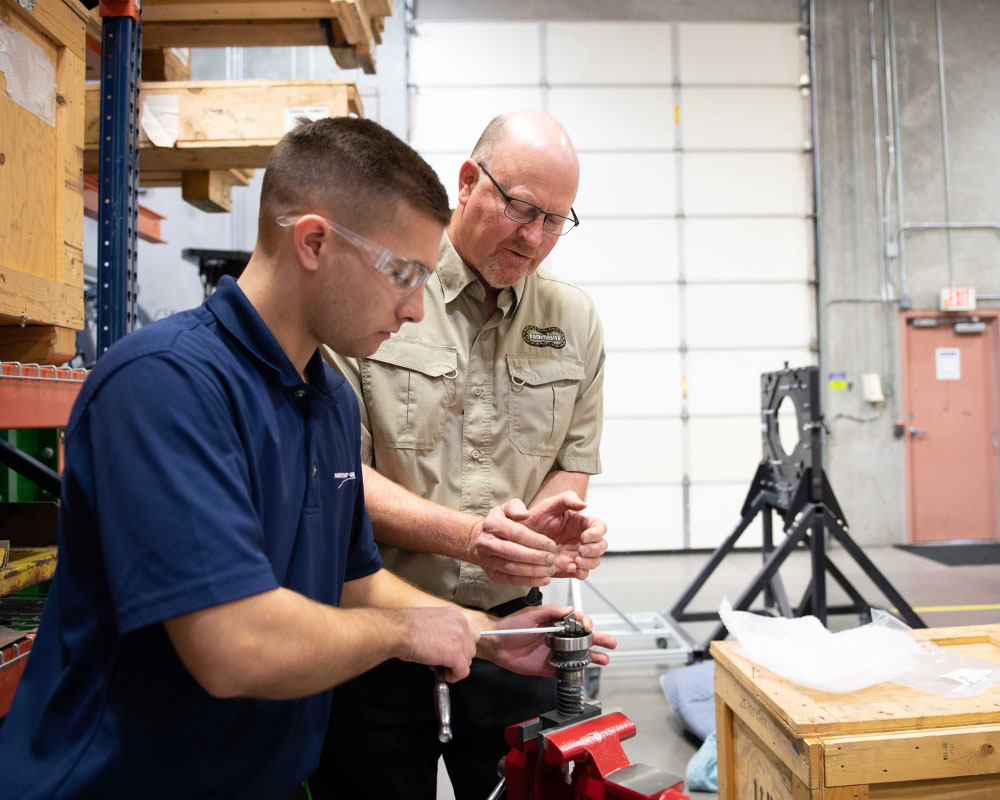 two men working with hands